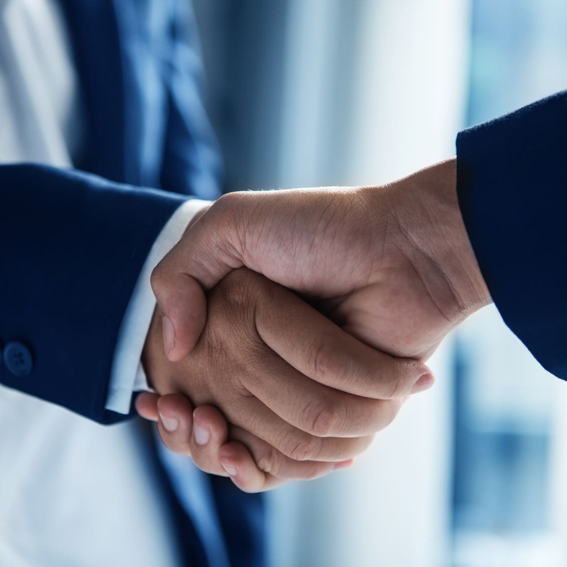 An employer and candidate shaking hands.